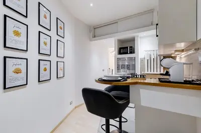 a kitchen with a counter and a black chair at Aventino Industrial Loft in Rome