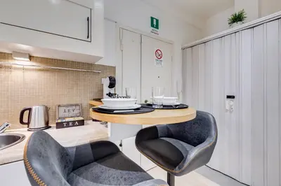 a kitchen with two chairs and a table at Aventino Industrial Loft in Rome