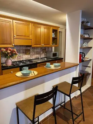 a kitchen with two chairs and a counter top at Home Bella Roma centro storico in Rome