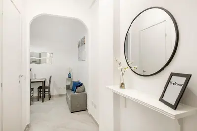 a hallway with a mirror and a table at White Flat San Lorenzo in Rome