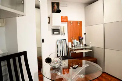 a dining room with a glass table in a room at Magnifico 122 Apartment in Rome