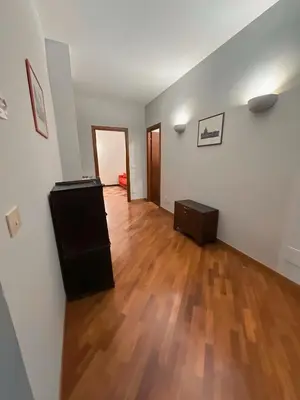 an empty living room with a hard wood floor at Ale home in Rome