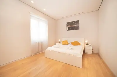 a white bedroom with a white bed and a window at Green Hill Buddyrent's in Rome
