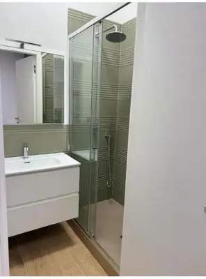 a bathroom with a sink and a glass shower at Cola di Rienzo 243 Relais-B in Rome