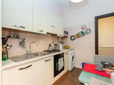 a kitchen with white cabinets and a sink and a dishwasher at Apartment Vatican - Residenza Argilla by Interhome in Rome