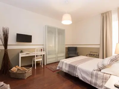 a bedroom with a bed and a desk and a tv at Apartment Vatican - Residenza Argilla by Interhome in Rome