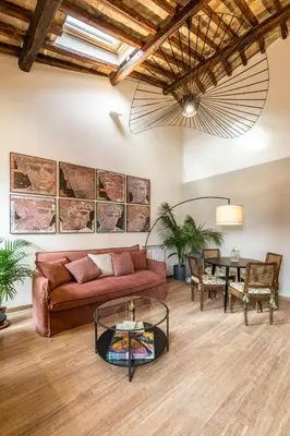 a living room with a couch and a table at Attico le Stelle de Roma in Rome