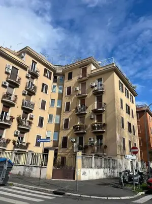 a large apartment building with balconies on a street at Casa Latina in Rome