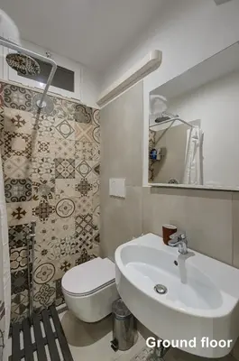 a bathroom with a white sink and a toilet at Casa a Monti in Rome