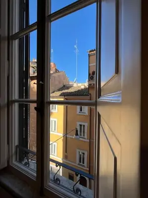 a view of a building from an open window at Boutique Signature Suite in the Heart of Ancient Rome in Rome