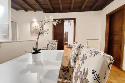 a white table with a vase with a plant on it at La Civetta a Navona in Rome