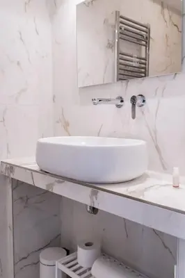 a white bathroom with a sink and a mirror at Domina Apartments Roma - San Pietro 1 in Rome
