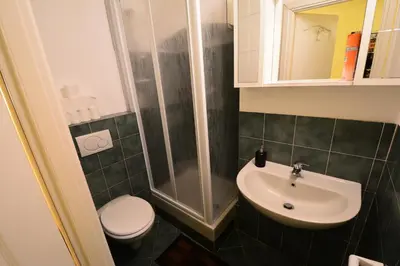 a bathroom with a sink and a toilet and a shower at Holiday City Center in Rome