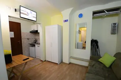 a living room with a couch and a table and a kitchen at Holiday City Center in Rome