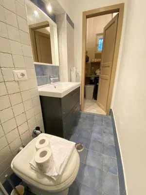 a bathroom with a toilet and a sink at Tiziano's house San Pietro Station in Rome