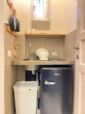 a small kitchen with a sink and a refrigerator at Tiziano's house San Pietro Station in Rome