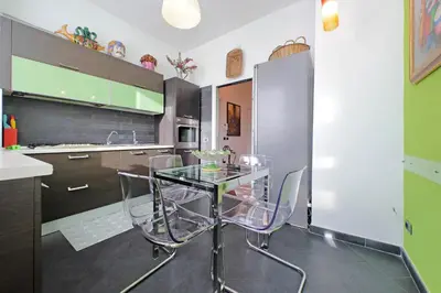 a kitchen with a glass table and chairs at YCH-Una finestra sulla Cupola di San Pietro in Rome