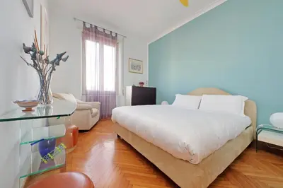 a bedroom with a bed and a glass table at YCH-Una finestra sulla Cupola di San Pietro in Rome
