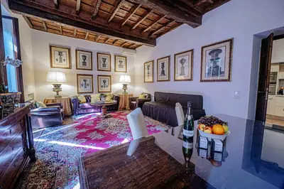 a living room with a couch and a table at Via Giulia Charming Apartment with Balcony in Rome