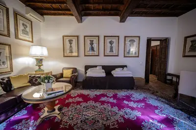a living room with a couch and a table at Via Giulia Charming Apartment with Balcony in Rome