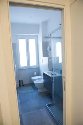 a bathroom with a toilet and a glass shower at A Casa di Lù a Roma Casa Vacanze in Rome