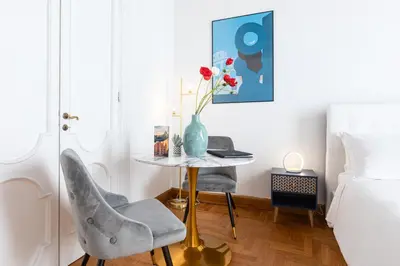 a bedroom with a table and two chairs and a bed at Spanish Steps Exclusive Apartment in Rome