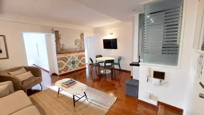 a living room with a couch and a table at Serpenti 147 - Colosseum Apt in Rome