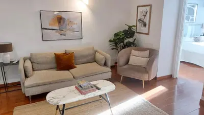 a living room with a couch and a chair at Serpenti 147 - Colosseum Apt in Rome