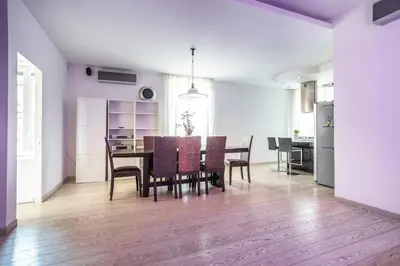 a kitchen and dining room with a table and chairs at Maximo Luxe -Villa & Apartment in Rome