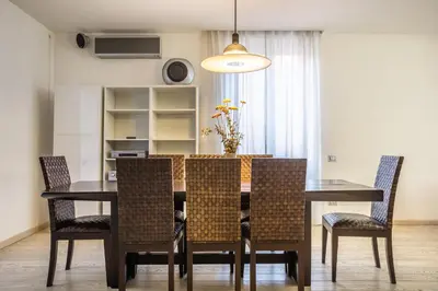 a dining room with a table and chairs at Maximo Luxe -Villa & Apartment in Rome