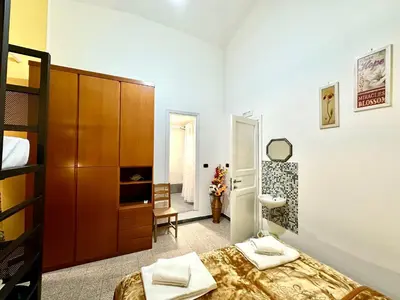 a bedroom with a bed and a bathroom at B&B Termini Colosseo Suite in Rome