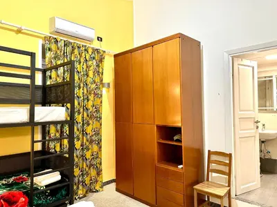 a bedroom with a bunk bed and a wooden cabinet at B&B Termini Colosseo Suite in Rome