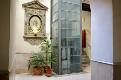 a hallway with a large glass door and potted plants at HC - In the heart of Campo de' Fiori in Rome