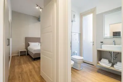 a bathroom with a toilet and a sink at Adelante Apartment in Rome
