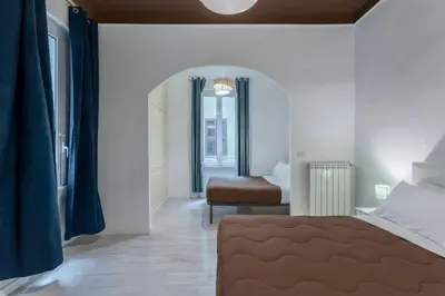 a bedroom with a bed and a chair in it at Gilda Apartment New elegant apartment in Termini in Rome