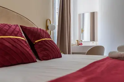 a bedroom with a bed with red pillows at Decimo Meridio- At Spanish Steps- in Rome