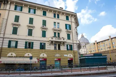 a large white building in front of a street at Holiday Home House Fornaci in Rome