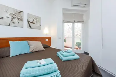 a bedroom with a bed with two towels on it at Roma Trastevere Relais Guest House in Rome