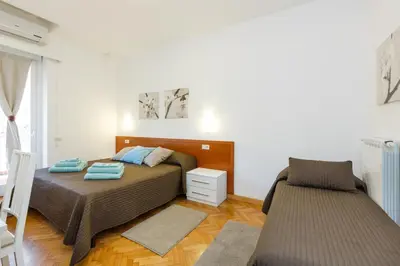 a bedroom with a bed and a chair in it at Roma Trastevere Relais Guest House in Rome