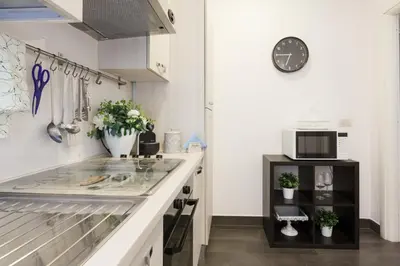 a kitchen with a sink and a counter top at Roma Trastevere Relais Guest House in Rome