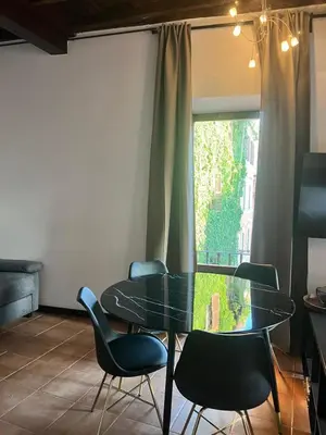 a dining room with a glass table and chairs at Imperial House San Calisto 7 in Rome
