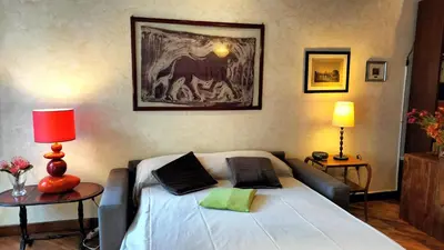 a bedroom with a bed and a painting on the wall at Benedetta Suite Trastevere in Rome
