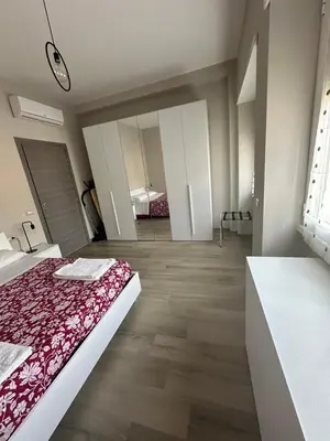 a bedroom with a bed with a red blanket at Casa Sofia, a 4 fermate metro dal Vaticano in Rome