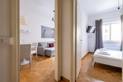 a small white room with a couch and a table at Charming suite with view in the heart of Rome in Rome