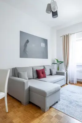 a living room with a gray couch with red pillows at Charming suite with view in the heart of Rome in Rome