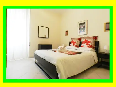 a bedroom with a bed with a teddy bear on it at Re di Roma House in Rome
