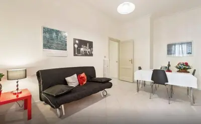 a living room with a couch and a table at Re di Roma House in Rome