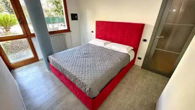 a bed with a red headboard in a room at D10S SANPIETRO in Rome