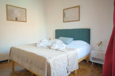 a bedroom with a bed with a green headboard at Fontana di Trevi sweet apartment in Rome