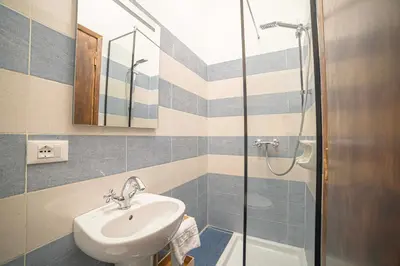 a bathroom with a sink and a shower at Fontana di Trevi sweet apartment in Rome